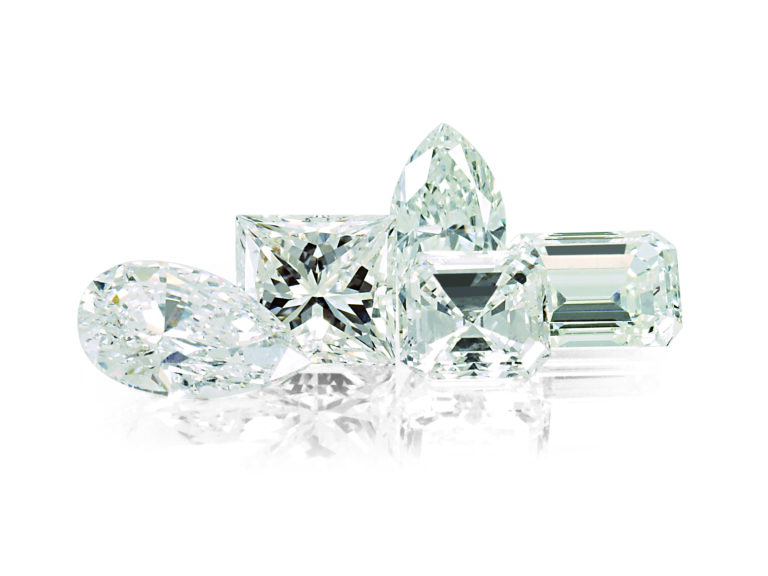 Lab-grown diamonds in various cuts including pear, princess, and emerald shapes, symbolizing ethical engagement ring choices.