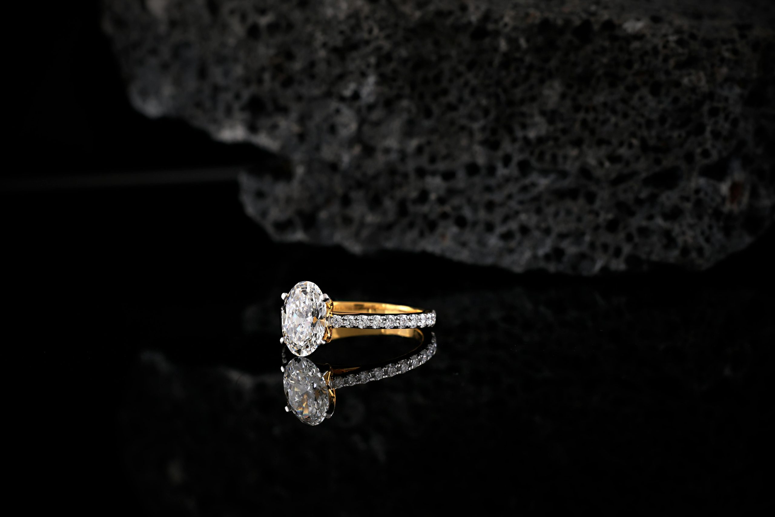 Diamond engagement ring with oval cut center stone and delicate band, reflecting current 2026 trends in timeless elegance and individuality.